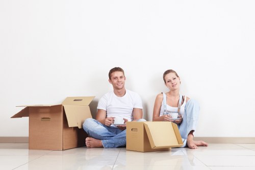 Professional movers handling office furniture and equipment in central London