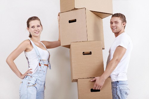Worker applying safe lifting practices while handling furniture