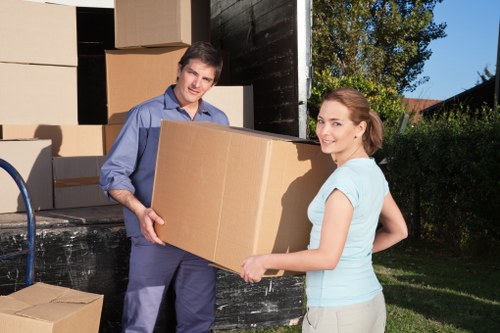 Moving team handling boxes and furniture in a central London property